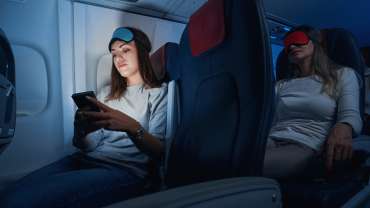 Mulher em um avião para um vôo noturno